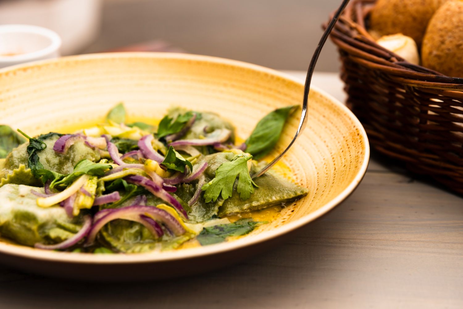 plate-green-ravioli-pasta-with-onion-coriander-leaves-koriandr-listy